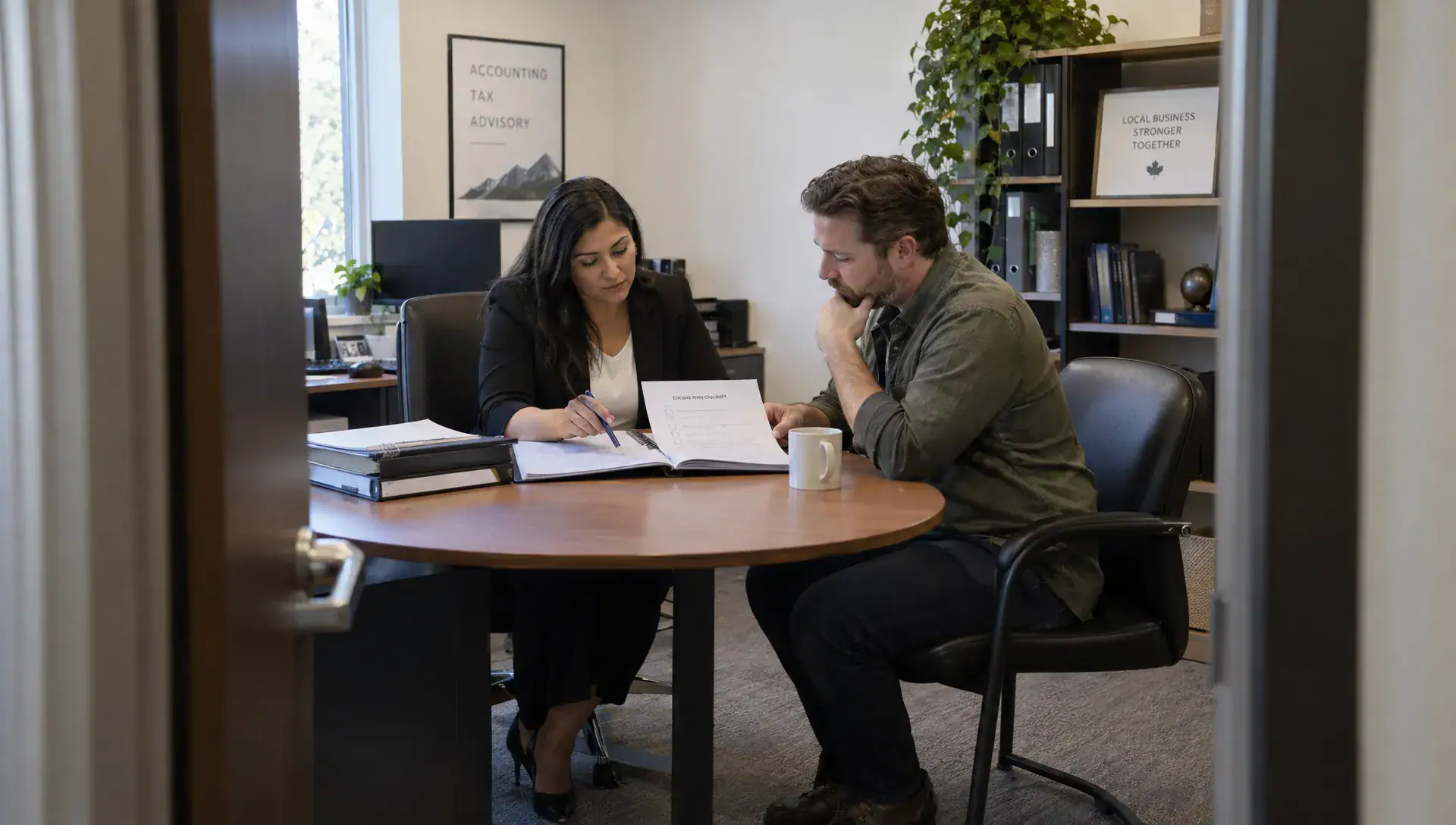 An accountant and business owner review closure documents and a checklist for an inactive corporation.